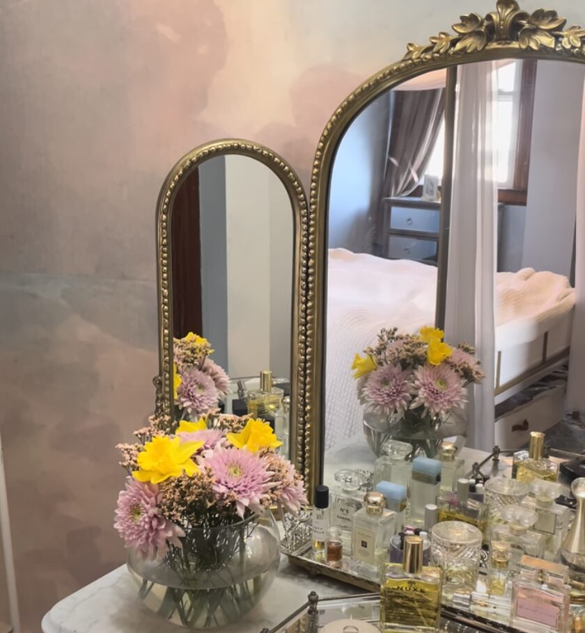 Vintage vanity with flowers and perfumes