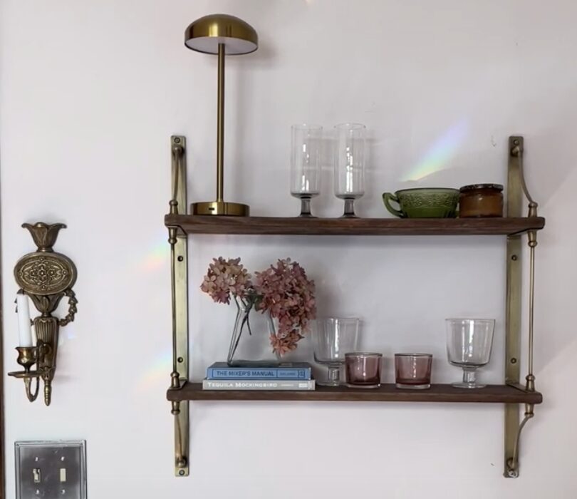 Brass and wood shelf with glassware